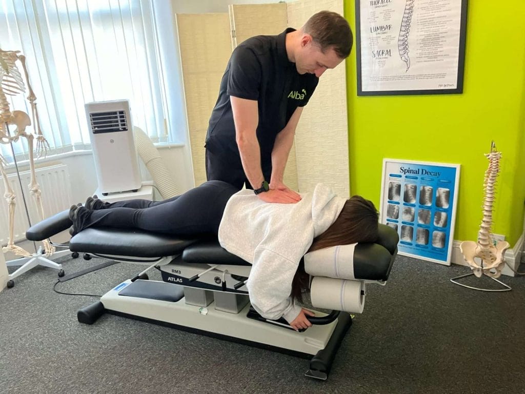 a person performing massage therapy for spinal health on a patient